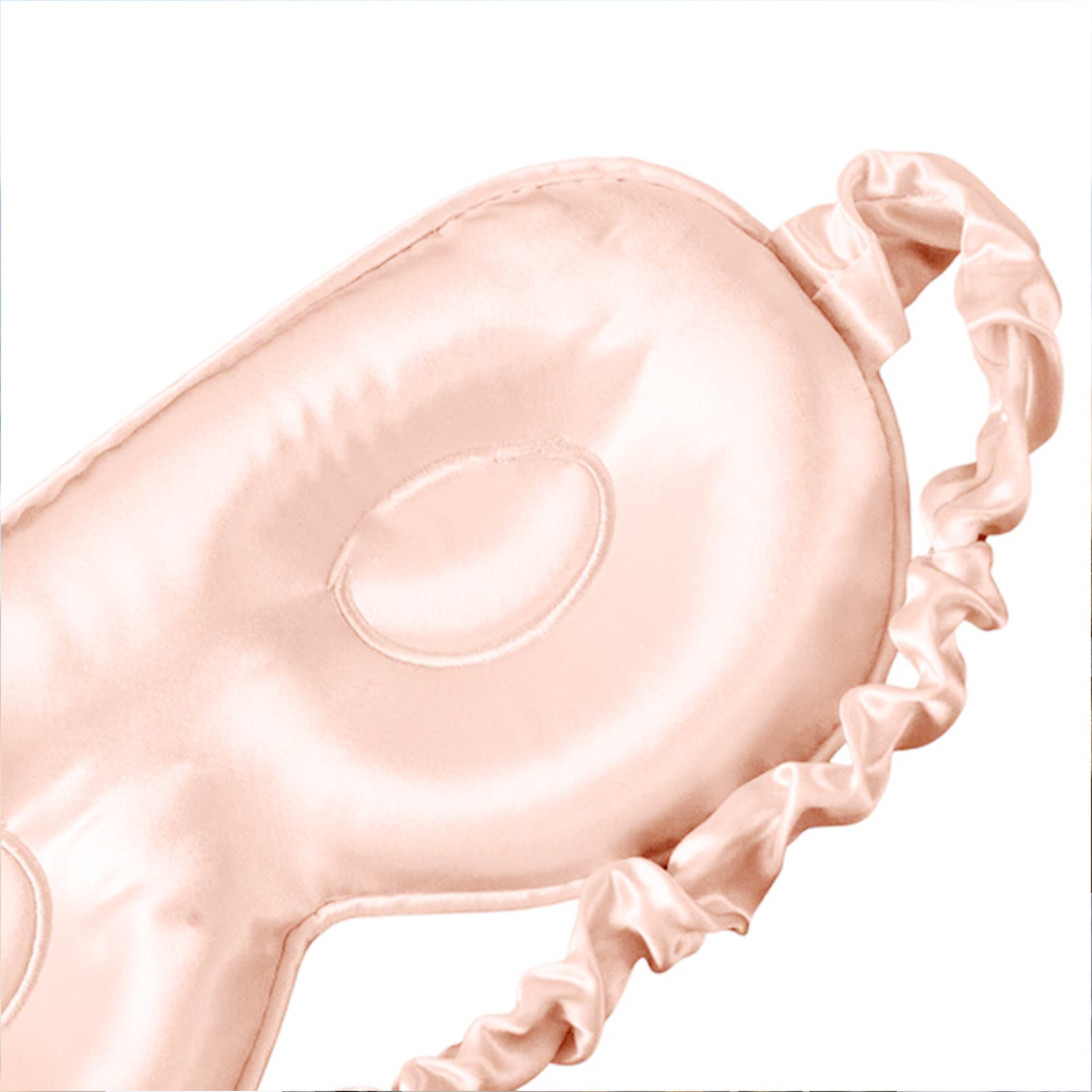 Close up of 3D contoured eye cavities on pink silk mask
