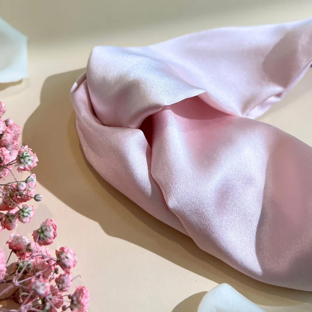 Close up of light pink silk headband with dried flowers
