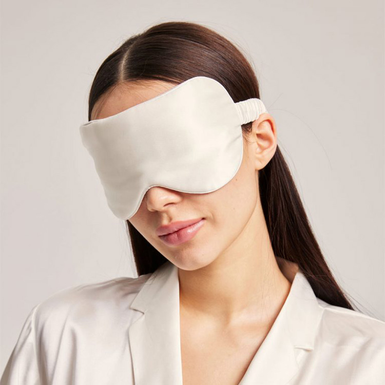 Model wearing silver silk sleep mask front view