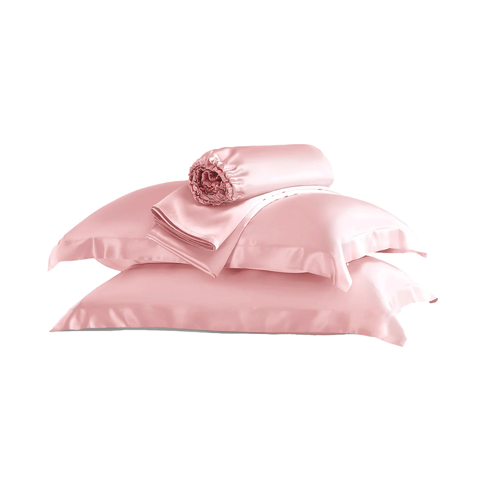Folded pink silk bedding set flat lay