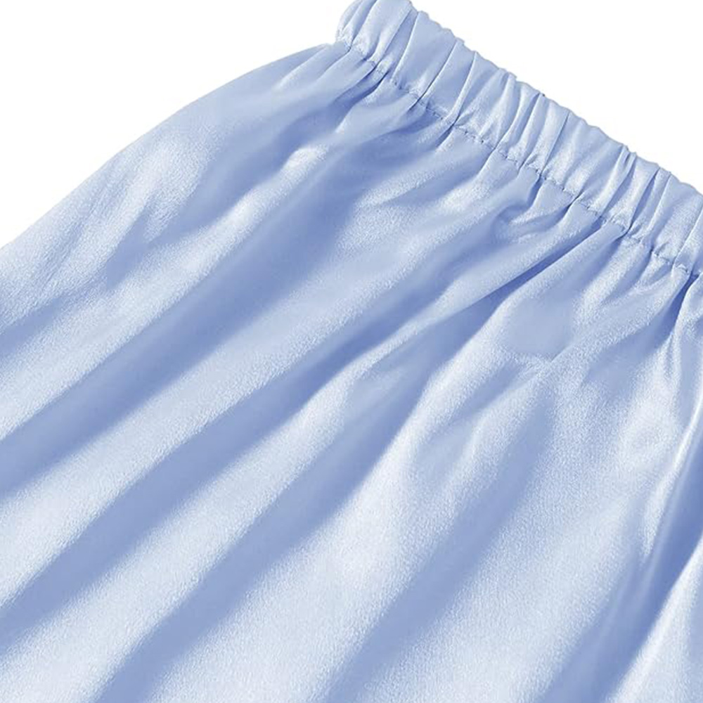 Elastic waistband detail on light blue silk pajama shorts
